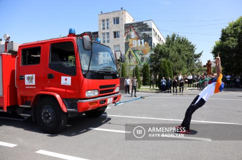 Record holder Yuri Sakunts pulls two fire-rescue vehicles with
teeth seeking to set a new Guinness record