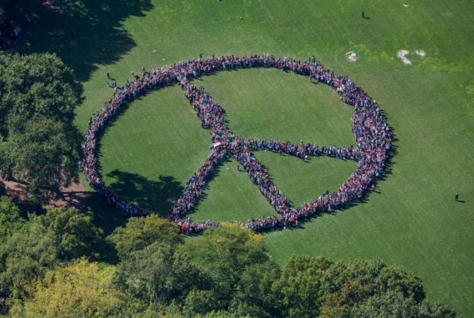 John Lennon honored in New York as thousands form peaces