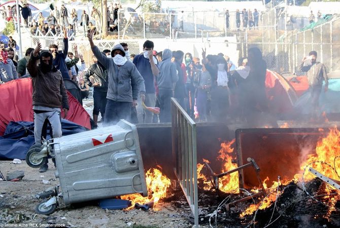Migrants protest at Greek Lesbos refugee camp, service offices set on fire