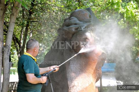 Armenian-American Ara Tovmasyan cleans statues at Yerevan 
Children's Railway