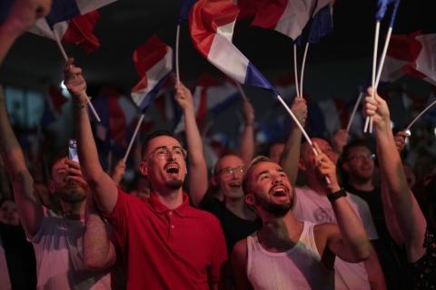 Supporters of French far right leader Marine Le Pen react after the release of projections based on the actual vote count in select constituencies , Sunday, June 30, 2024 in Henin-Beaumont, northern France. French voters propelled the far-right National Rally to a strong lead in first-round legislative elections Sunday and plunged the country into political uncertainty, according to polling projections. (AP Photo/Thibault Camus)