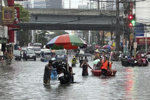 Streets flood from monsoon rains worsened by offshore typhoon Gaemi on Wednesday, July 24, 2024, in Manila, Philippines. (AP Photo/Joeal Capulitan)