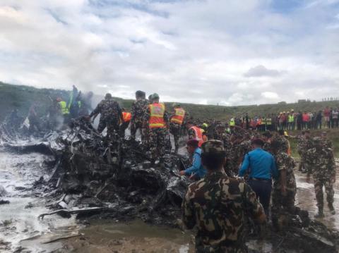 Emergency services work at the accident site of a Saurya Airlines plane that caught fire after skidding off the runway while taking off, in Kathmandu, Nepal July 24, 2024.     NepaliArmyHQ via X/Handout via REUTERS