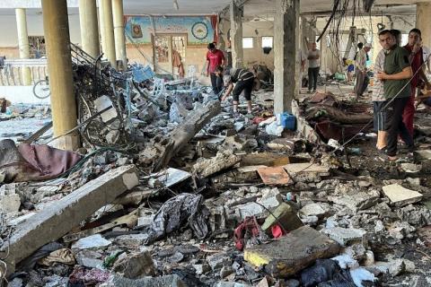 Palestinians inspect the site of an Israeli strike on a school sheltering displaced people, amid the Israel-Hamas conflict, in Gaza City, August 10, 2024. REUTERS/Abed Sabah