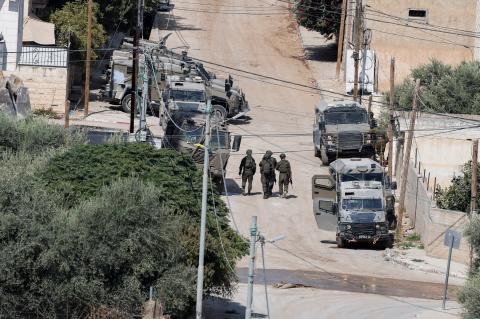 Israeli security forces walk next to armoured vehicles during an Israeli raid in Jenin during an Israeli raid, in Jenin, in the Israeli-occupied West Bank, September 3, 2024. REUTERS/Raneen Sawafta