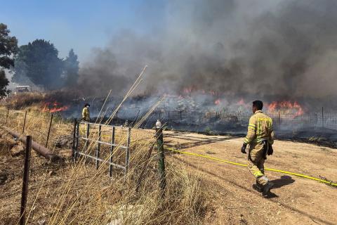 Israeli firefighters work following rocket attacks from Lebanon, amid ongoing cross-border hostilities between Hezbollah and Israeli forces, near the border on its Israeli side, June 13, 2024. REUTERS/Avi Ohayon