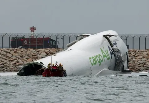 Cargo plane slides off runway in Hong Kong, killing two airport staff
