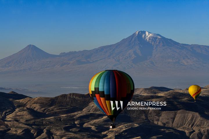 Colorful hot air balloons soar over Garni