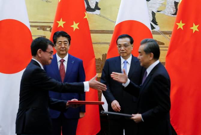 Japan, China strike deals worth $2.6 billion during Abe visit