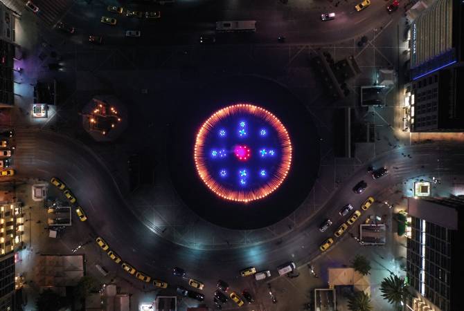 The City Hall of Rhodes and fountains of Omonia Square of Athens illuminated in the colors of 
Armenian flag