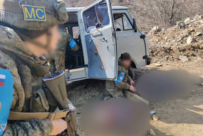 Azeri attack repelled by police, Defense Army; Russian peacekeepers seen inspecting 
bullet-sprayed police cruiser 